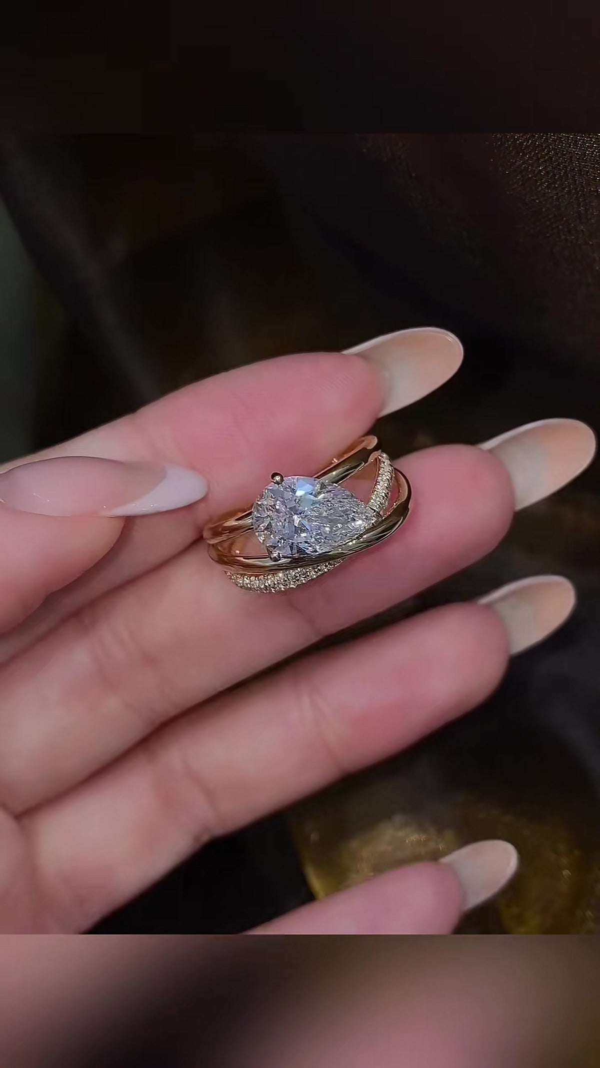 Close-up of lab-grown diamond pear stacking engagement ring for stylish proposals