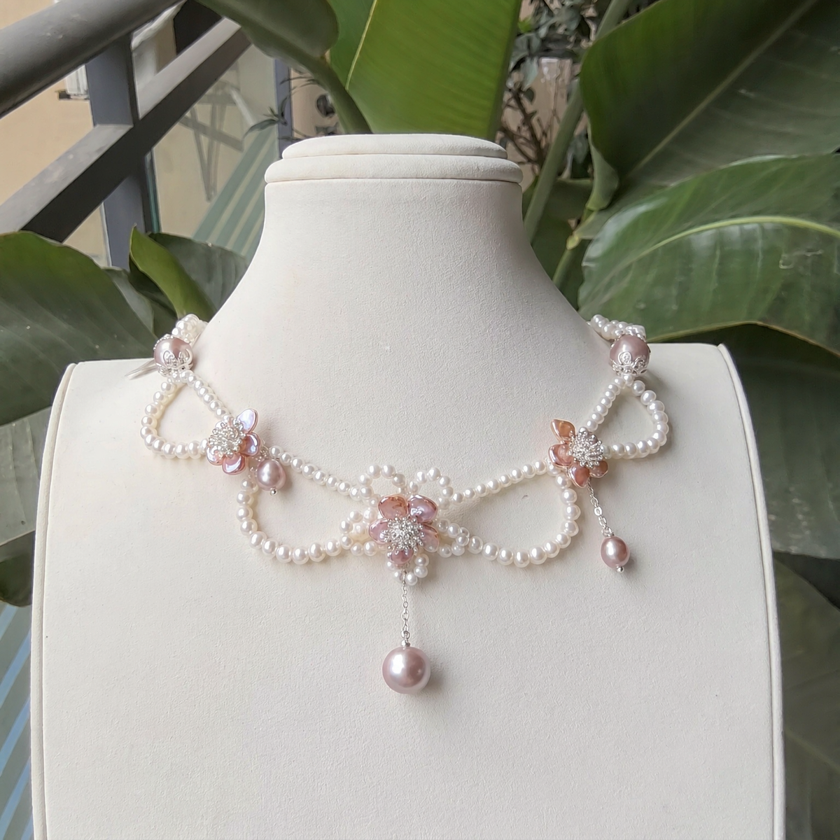 Front view of Rosé Blossom Pearl Necklace, a natural freshwater pearl necklace for romantic weddings