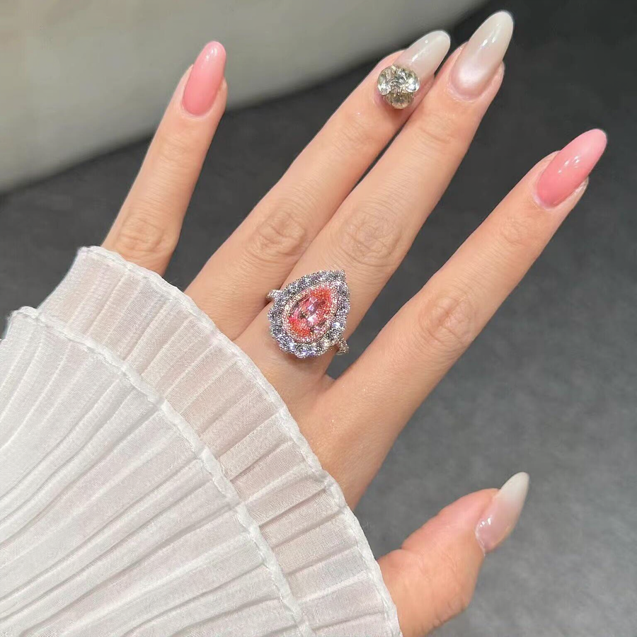 Front view of pear-cut lab-grown pink diamond halo ring for romantic proposals
