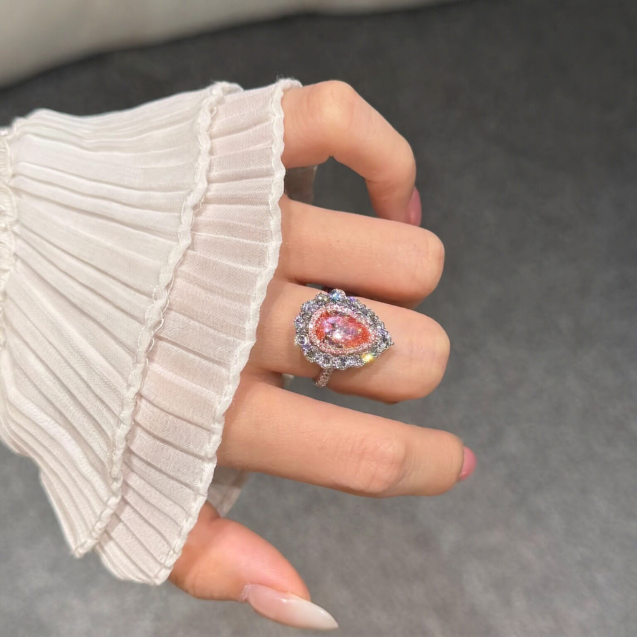 Styled view of pear-cut lab-grown pink diamond halo ring for romantic proposals