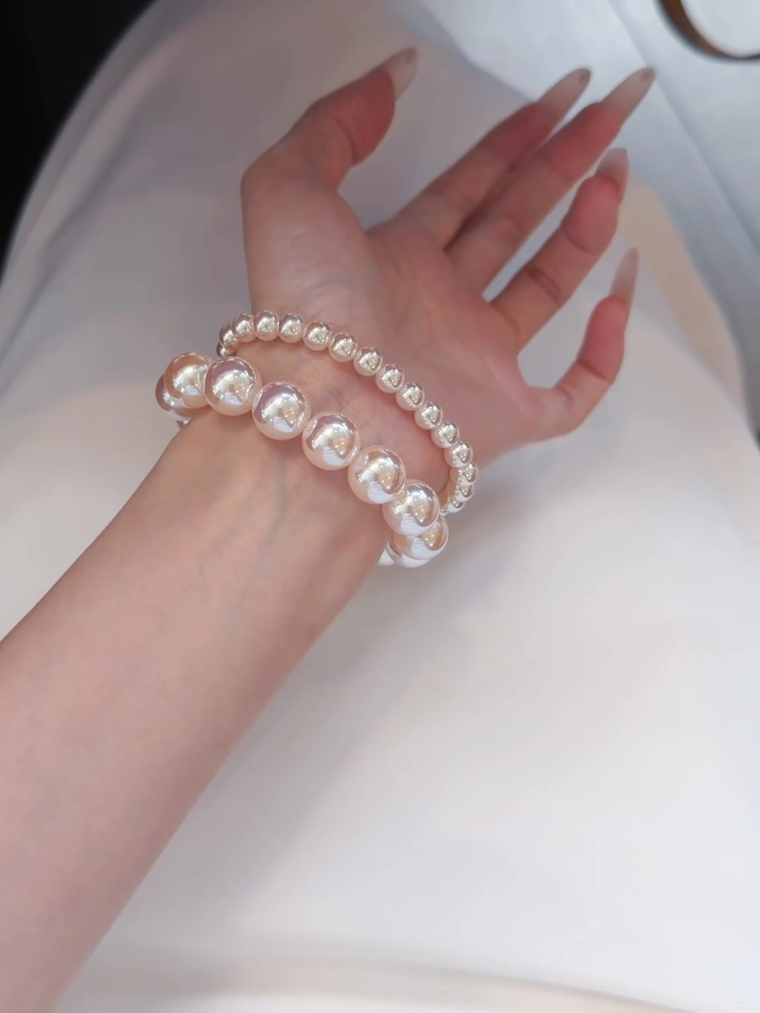 Styled view of pink high-lustre freshwater pearl bracelet for bridal styling