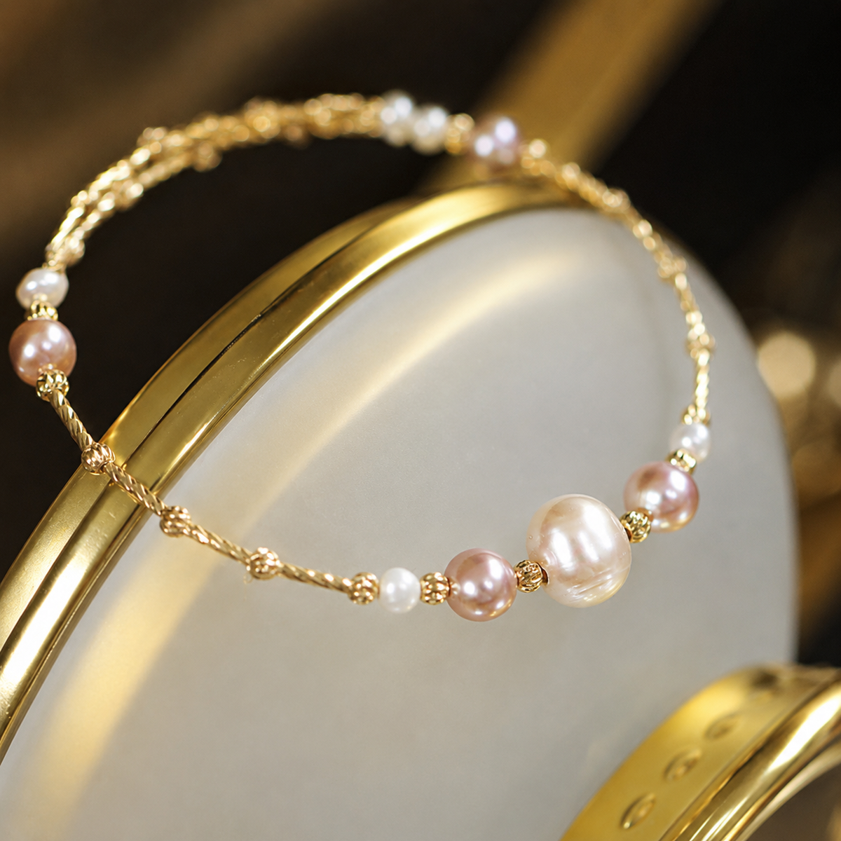 Close-up of a 14K solid gold bracelet with graduated freshwater pearls