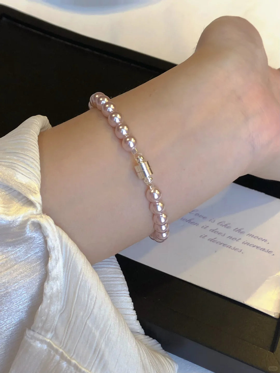 Styled view of pink pearl high-lustre freshwater pearl bracelet for bridal styling