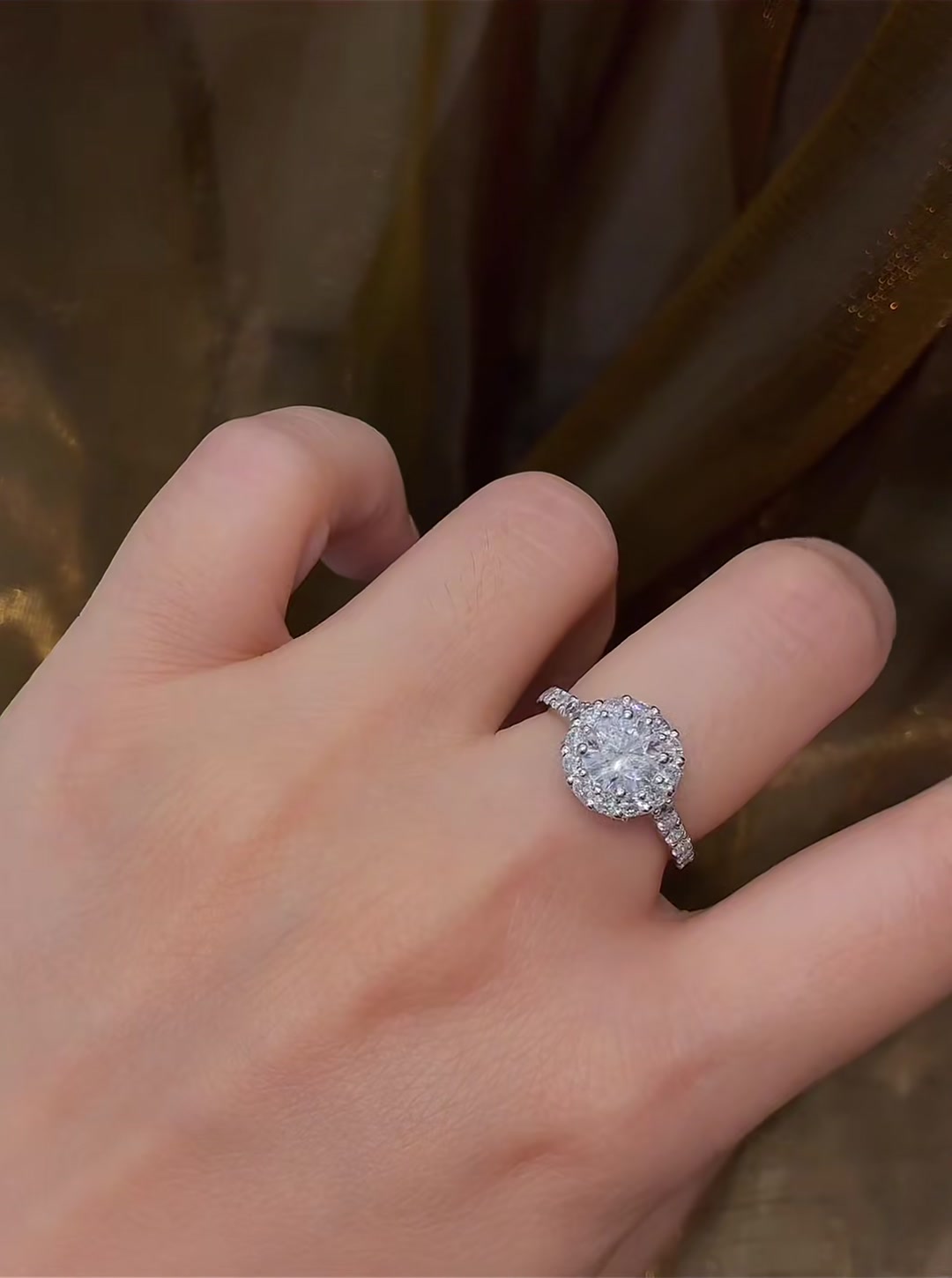 Close-up of lab-grown diamond round halo engagement ring for classic proposals