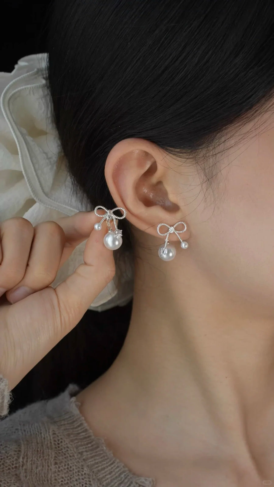 Front view of bow drop high-lustre freshwater pearl earrings for wedding guest looks