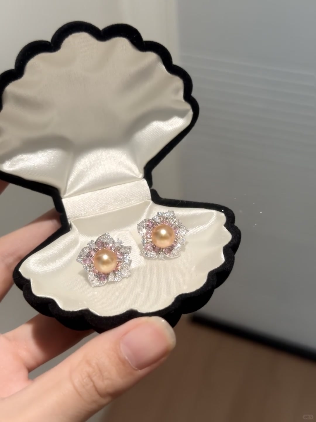 Styled view of golden flower stud high-lustre freshwater pearl earrings for wedding guest looks
