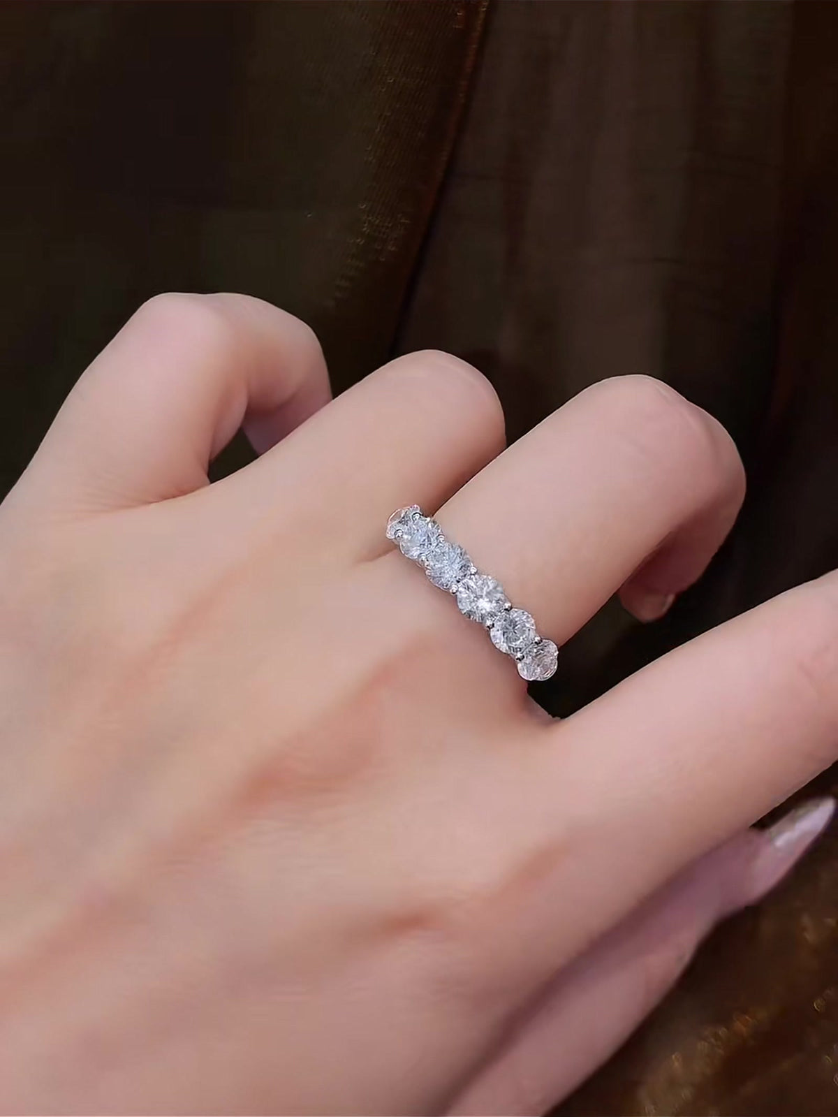 Styled view of lab-grown diamond seven stone anniversary band for wedding stacks