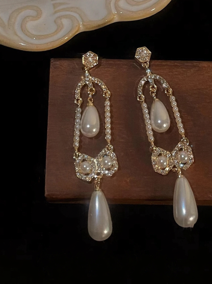 Front view of filigree drop high-lustre freshwater pearl earrings for wedding guest looks
