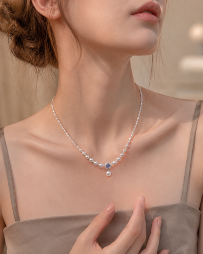 Model wearing a freshwater pearl and aquamarine necklace