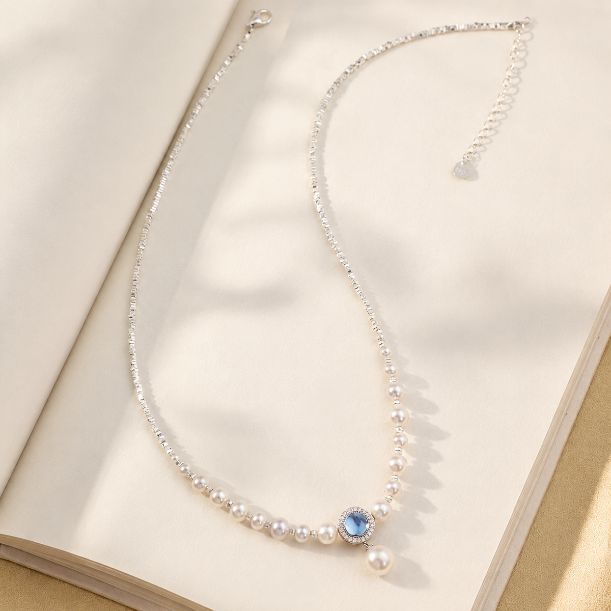 Detailed view of graduated freshwater pearls and a blue aquamarine centre