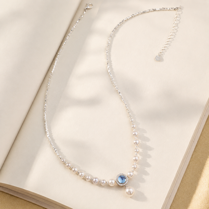 Detailed view of graduated freshwater pearls and a blue aquamarine centre