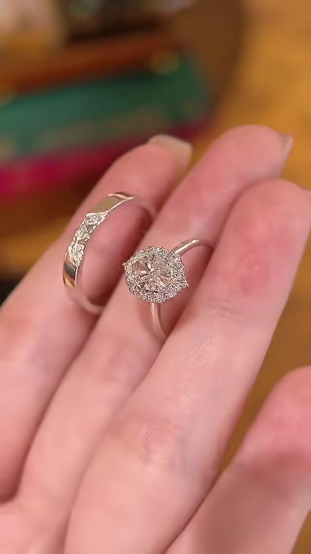 Close-up of lab-grown diamond oval halo bridal ring set for engagement proposals