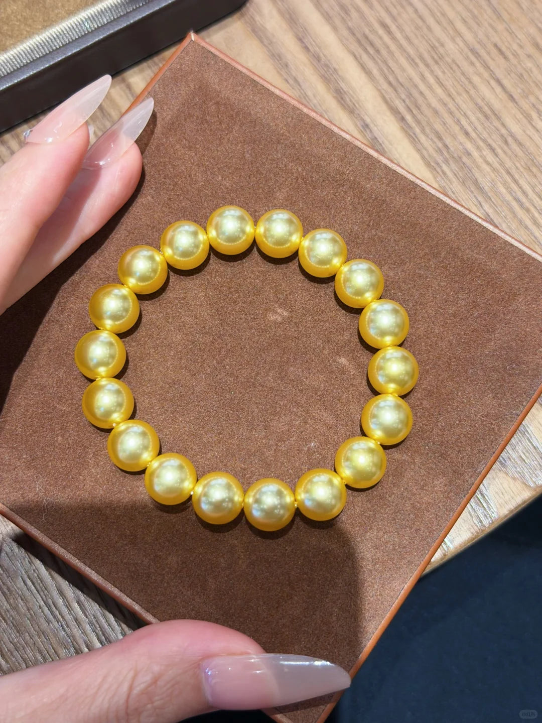 Styled view of golden strand high-lustre freshwater pearl bracelet for bridal styling