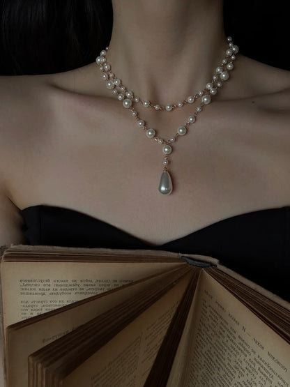 Detail view of layered y high-lustre freshwater pearl necklace for weddings