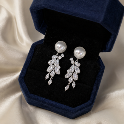 Akoya pearl and sterling silver leaf earrings presented in a navy jewellery box