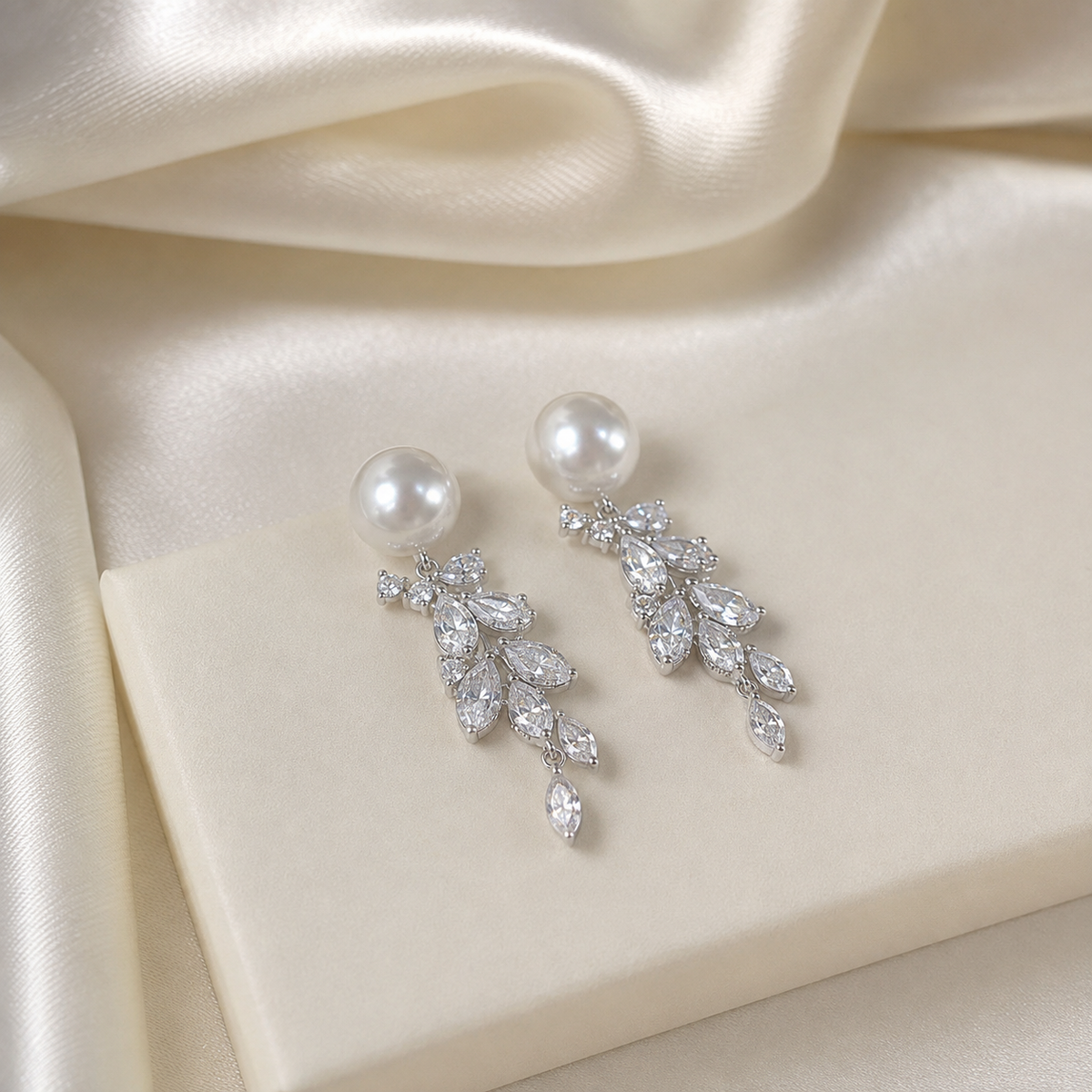 Detailed view of Akoya pearl studs and cascading clear-stone leaves