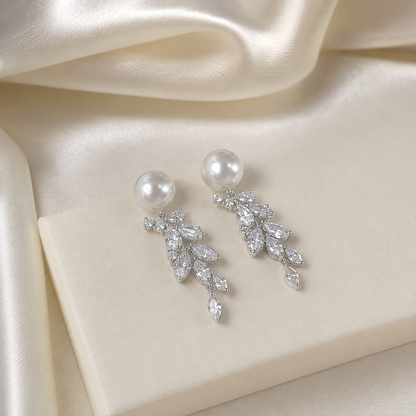 Detailed view of Akoya pearl studs and cascading clear-stone leaves