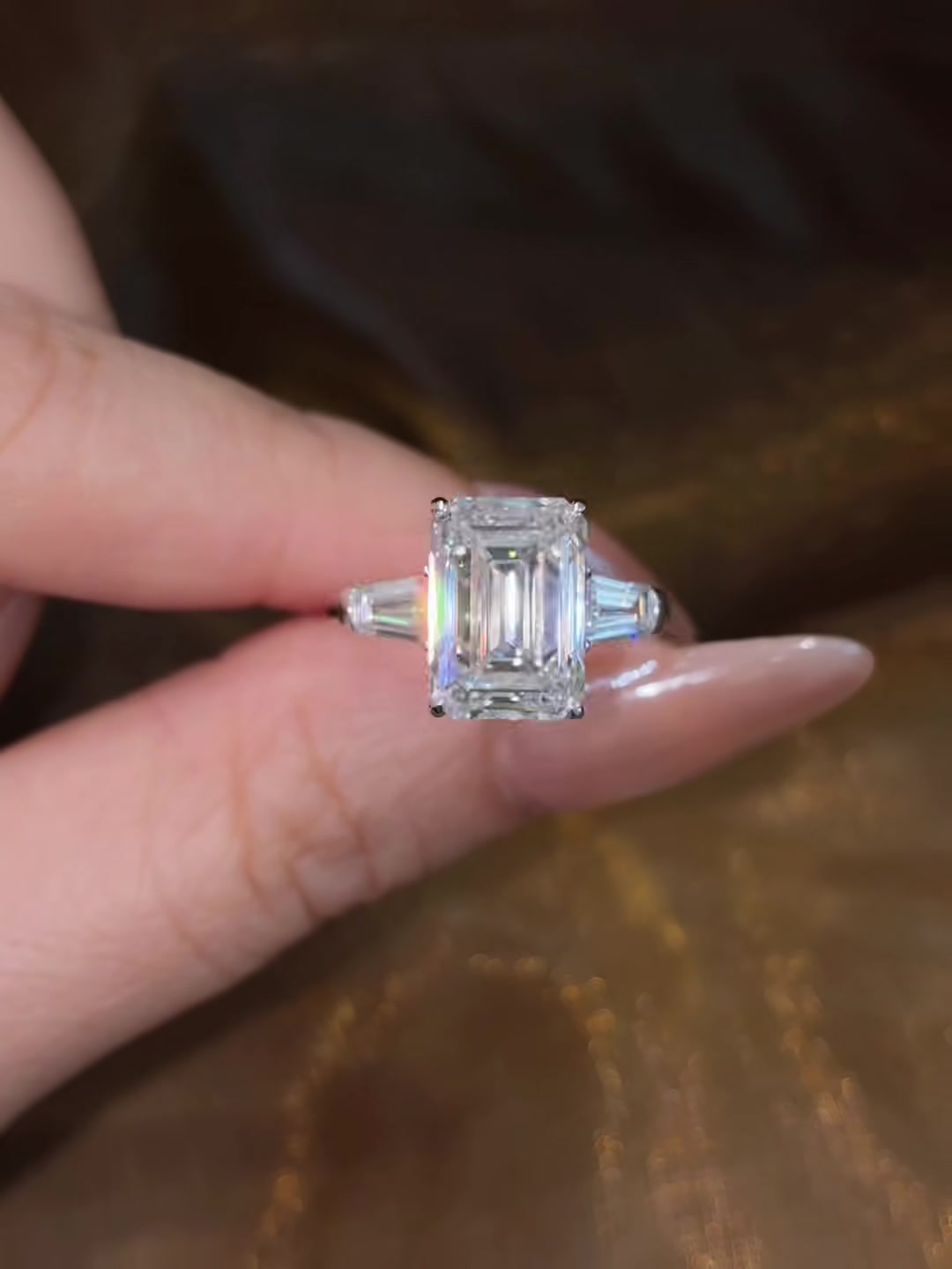 Front view of lab-grown diamond emerald cut trilogy engagement ring for timeless proposals