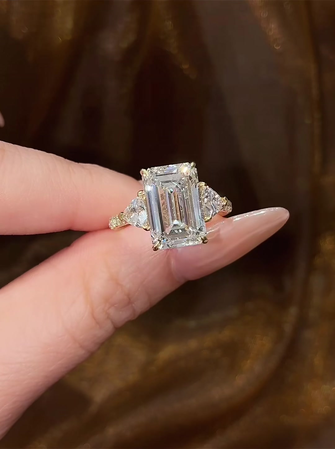Front view of lab-grown diamond emerald cut three stone ring for elegant proposals
